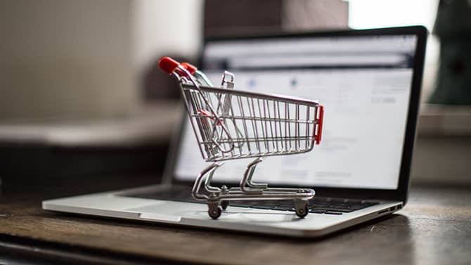 online shopping- laptop and shopping cart